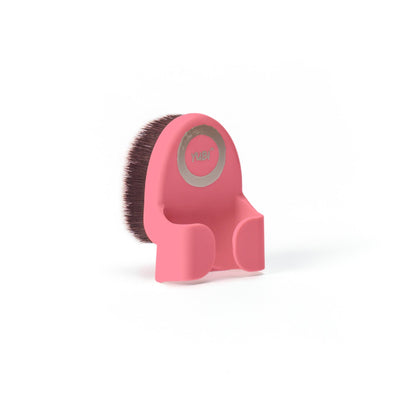 Rear angle view of candy pink Yubi Buff Brush handle with brown and white tipped brush attached.